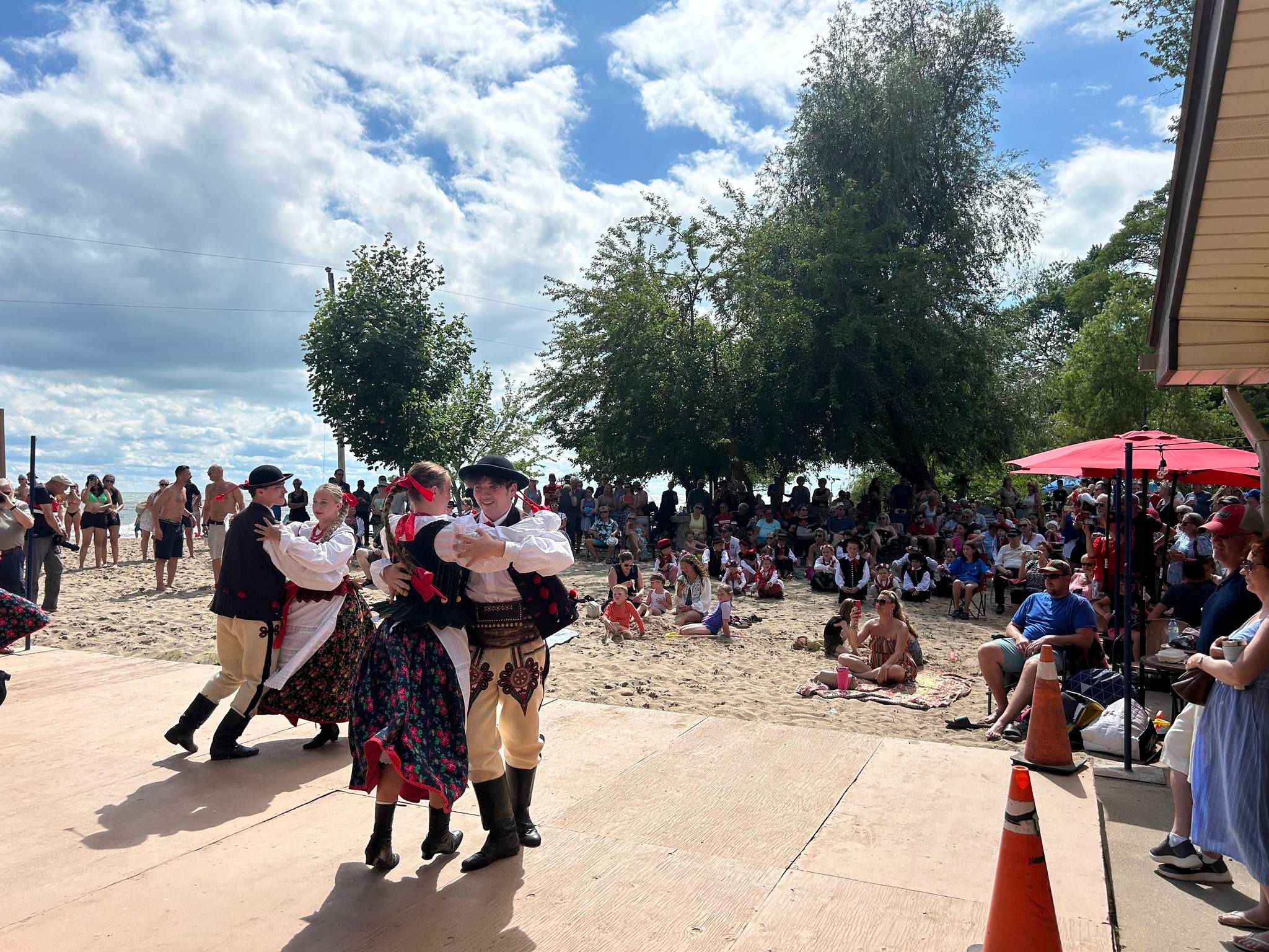 People gathering on the beach for an event.